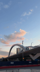 Electric river taxi cruises Moscow waterway during sunset golden hour