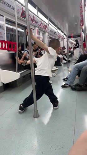 Boy plays with pole on metro train in China