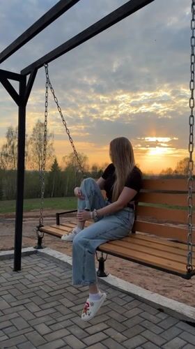 Casual backyard gathering with swing, grilling activities in Kamennoye