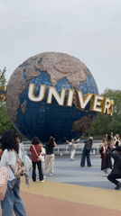 Visitors gather at Universal Studios Beijing globe for photos