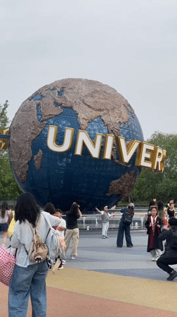 Visitors gather at Universal Studios Beijing globe for photos