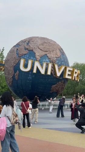 Visitors gather at Universal Studios Beijing globe for photos