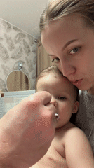 Woman documented in domestic moments with baby in Reshetnikovo
