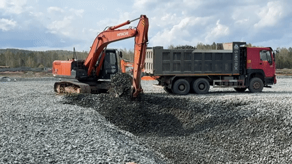 Construction equipment operates on muddy roads in Leninsk, Russia