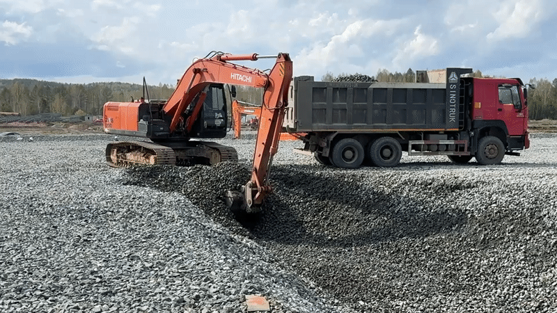 Construction equipment operates on muddy roads in Leninsk, Russia