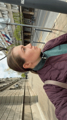 Woman walks past ornate buildings and flower gardens in Belgrade