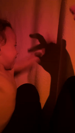 Child plays in makeshift fort during evening in Kiryat Bialik