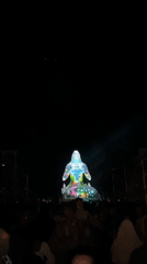 Nighttime light projections and flashlight exploration at an outdoor event