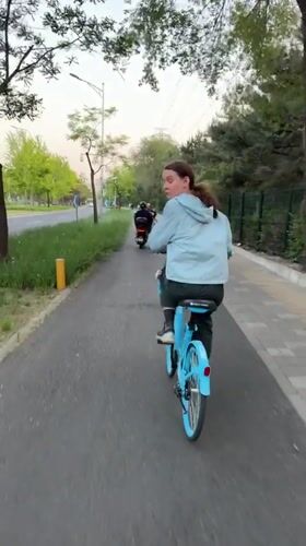 Cyclists spotted on paved path in Beijing's Chaoyang District