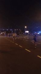 Night marathon runners traverse wet streets in Wrocław