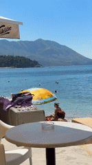 Summer morning on the Budva waterfront — beach, boats, and parasails