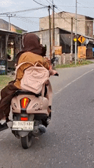 Pink scooter duo rolling through Keudebayu roads