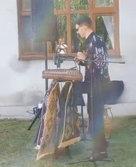 Dulcimer performance and circle dancing at outdoor folk gathering in Sniatyn