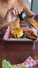 Man prepares burger breakfast in Kuta Selatan