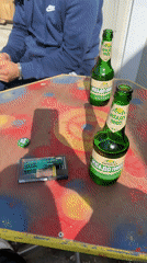 Man relaxes at Bulgarian repair shop with beer, cigarettes