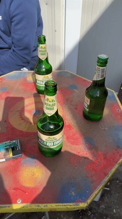 Man relaxes at Bulgarian repair shop with beer, cigarettes