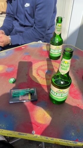 Man relaxes at Bulgarian repair shop with beer, cigarettes