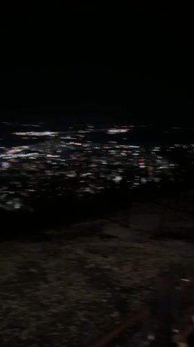 Nighttime city lights captured from elevated viewpoint in Shumen