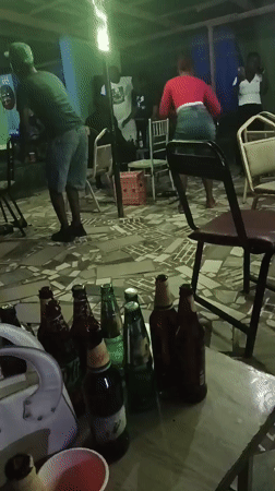 Beer, green lights, and dancing at a casual party gathering