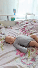 Baby observed resting on floral bed in Andreyevo