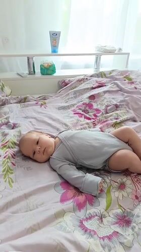 Baby observed resting on floral bed in Andreyevo