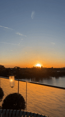 Sunset viewed over London waterway from residential balcony