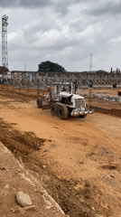 Heavy construction equipment operates at building site in Jos