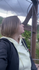 Woman films outdoor selfie session among wildflowers and greenery