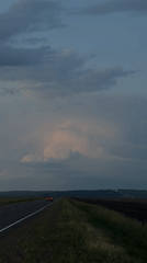 Dusk driving on a stormy rural highway near Kurgany, Russia