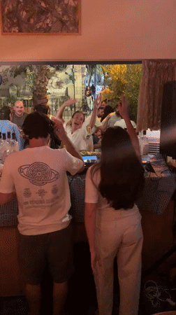 Nighttime social gathering with DJ captured in Tel-Aviv