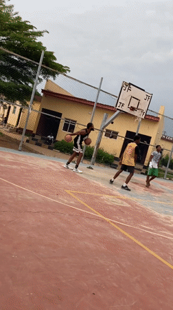Young men play basketball on outdoor court in Lagos