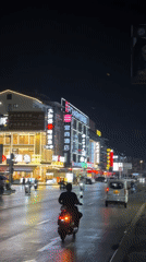 Nighttime street activity observed in downtown Guilin after rain
