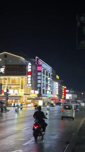 Nighttime street activity observed in downtown Guilin after rain