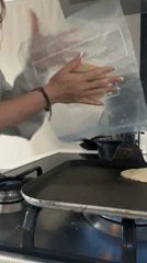 Woman prepares tortilla dough in early morning kitchen session