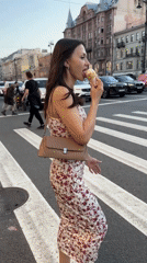 Woman enjoys ice cream while crossing street in Saint Petersburg
