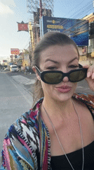 Woman walks Kuta street, mentions sunset plans