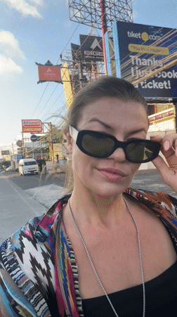 Woman walks Kuta street, mentions sunset plans