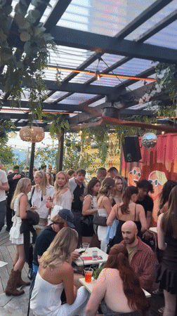 Rooftop party draws young crowd in Munich evening scene