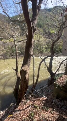 Muddy river flows rapidly through Stara Kresna Bulgaria