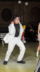 Purple-haired performer dances with woman in Nan'an District