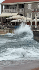 Large waves crash against seawall in Petrovac, Montenegro