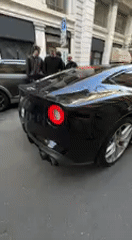 Luxury sports cars draw crowd on Milan street
