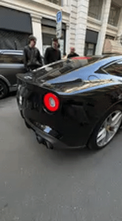 Luxury sports cars draw crowd on Milan street