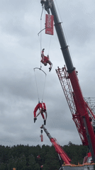 Aerial acrobats perform suspended from cranes in Yekaterinburg