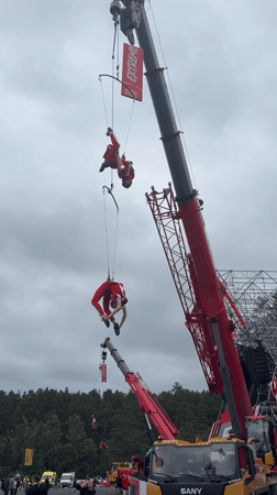 Aerial acrobats perform suspended from cranes in Yekaterinburg