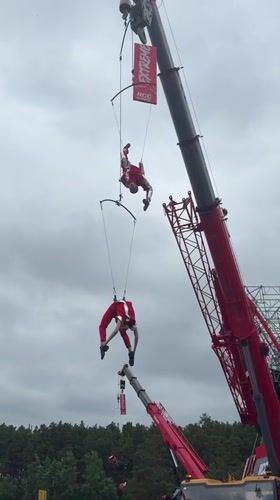 Aerial acrobats perform suspended from cranes in Yekaterinburg