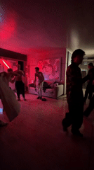 Young men dance in red-lit room in Naucalpan