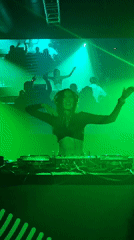 Female DJ performs in green-lit Samara nightclub venue