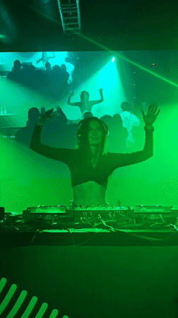 Female DJ performs in green-lit Samara nightclub venue