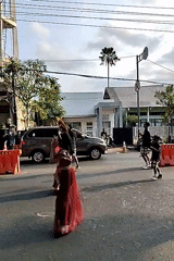 Traditional parade with dancers and effigy carriers in Malang